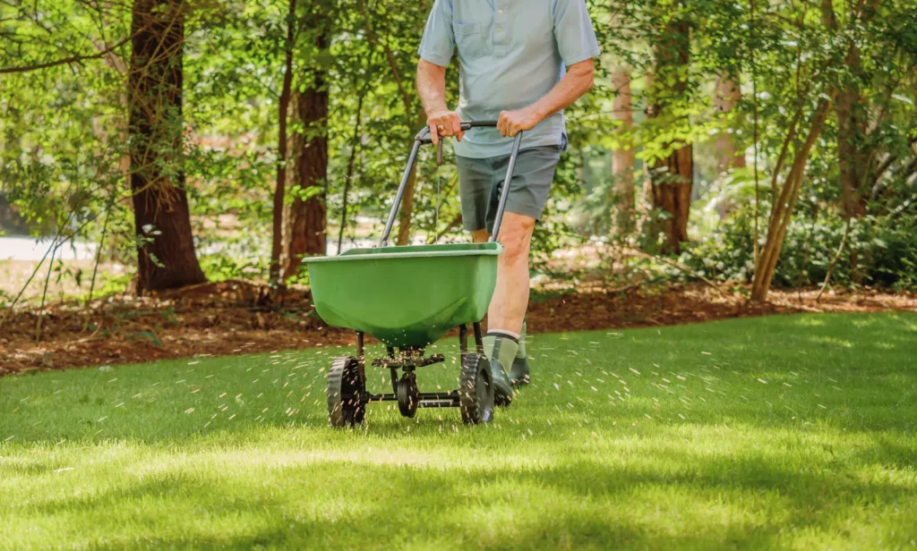 worker seeding lawn for a vibrant landscape discover the perfect Lawn Fertilization Timeline for a lush, healthy lawn